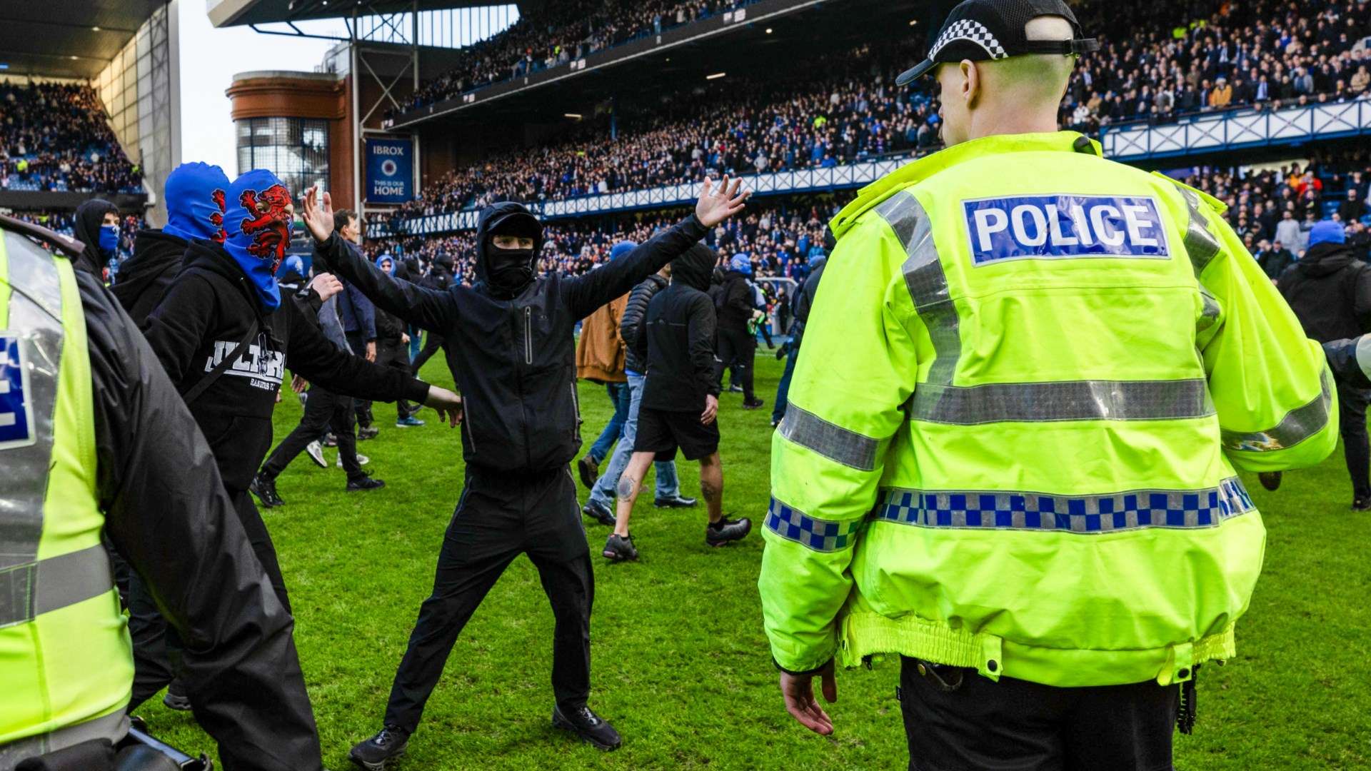 Celtic & Rangers fans separated by police in ugly pitch invasion  